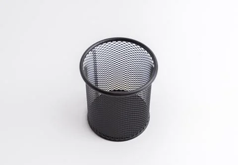 Empty black round metal mesh pen holder cup isolated on white background Stock Photos