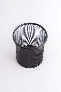 Empty black round metal mesh pen holder cup isolated on white background Stock Photos