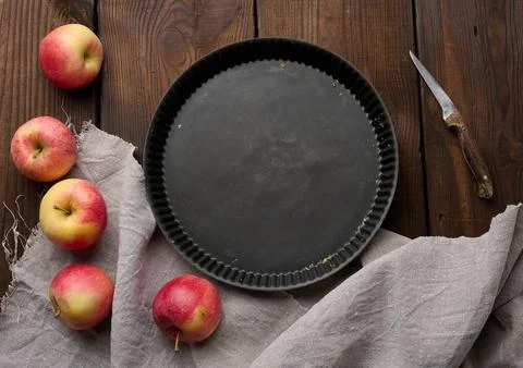 Empty black round non-stick cake pan on a brown wooden table Stock Photos