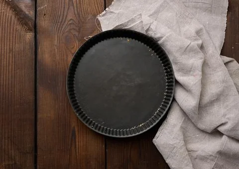 Empty black round non-stick cake pan on a brown wooden table Stock Photos