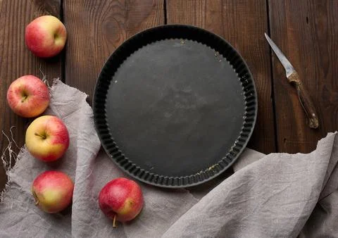 Empty black round non-stick cake pan on a brown wooden table Stock Photos