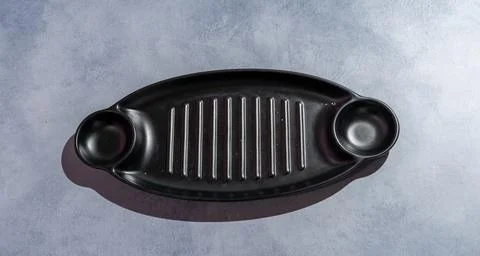 Empty Black Serving Platter with Handles on Gray Background Stock Photos