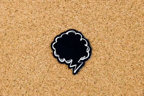 Empty black speech bubble over cork board background Stock Photos