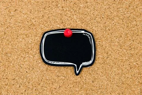 Empty black speech bubble pinned over cork board Stock Photos