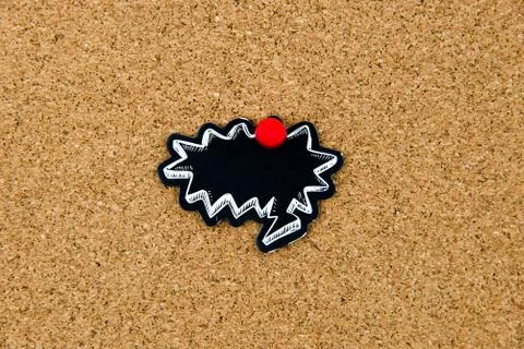 Empty black speech bubble pinned over cork board Stock Photos