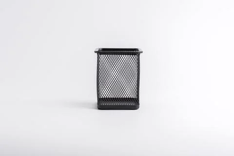 Empty black square metal mesh pen holder isolated on a white background Stock Photos
