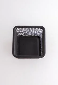 Empty black square metal mesh pen holder isolated on a white background Stock Photos