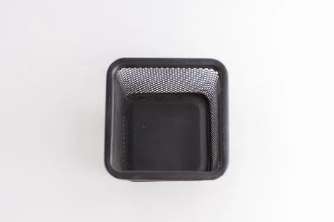 Empty black square metal mesh pen holder isolated on a white background Stock Photos
