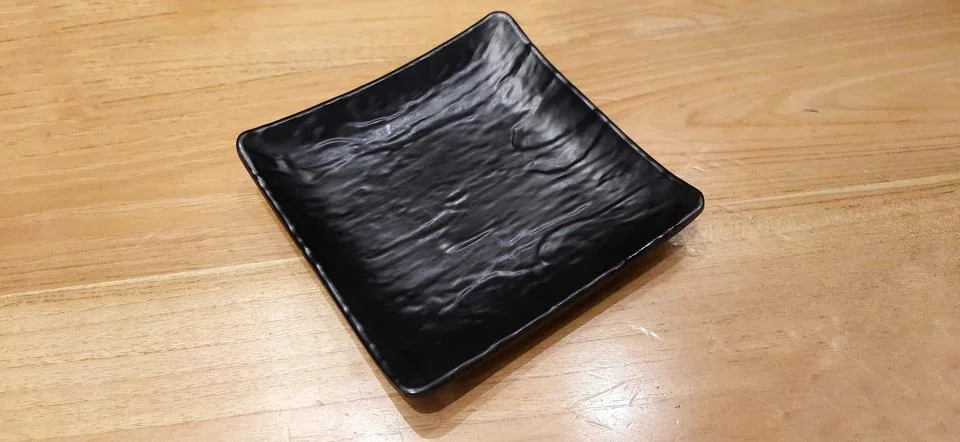 Empty black stone relief square plate with ceramic melamine material Stock Photos
