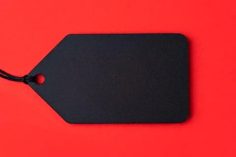 Empty black tag on red background Stock Photos