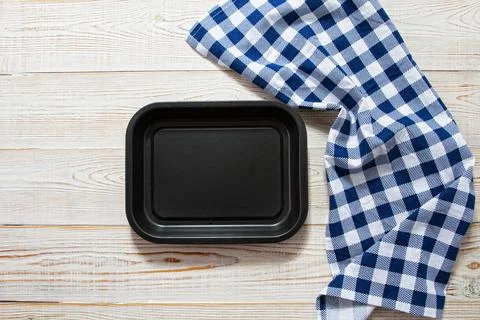 Empty black tray with checkered tablecloth top view on table Stock Photos