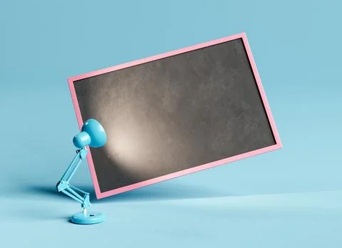 Empty blackboard and blue table lamp on blue backdrop Stock Photos