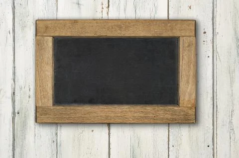 Empty blackboard on a rustic white wooden background 库存照片