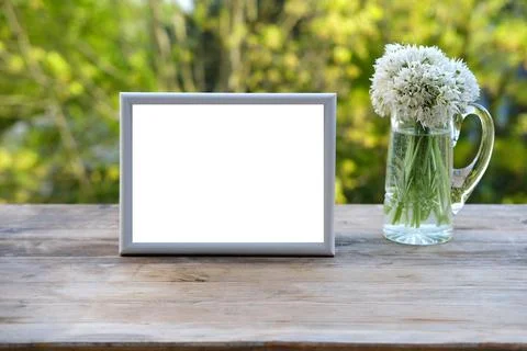 Empty blank in frame for designer, bouquet of wild garlic flowers on old wo.. Stock Photos