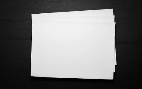 Empty blank horicontal sheets isolated on dark wood background to replace your Stock Illustration