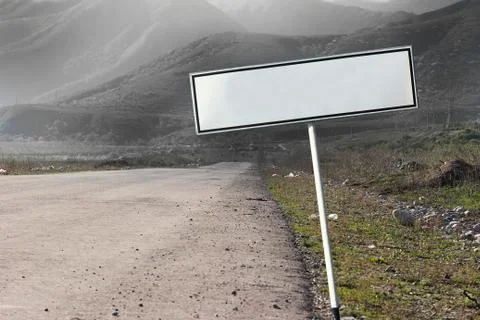 Empty blank road sign concept. The path extending into a gloomy distance. Stock Photos