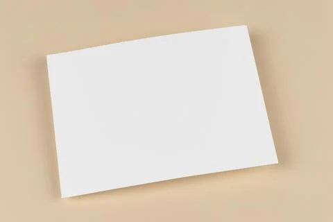 An empty blank sheet of paper on beige background. Template and mock up for Stock Photos