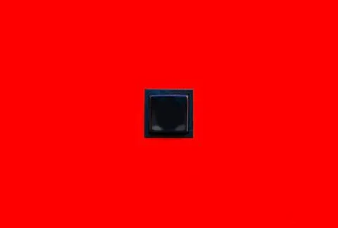 Empty blank small black square button in the middle of a bright vivid solid.. Foto stock