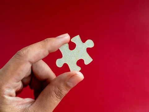 Empty blank space of a piece of puzzle jigsaw element in man's hand isolate.. Stock Photos