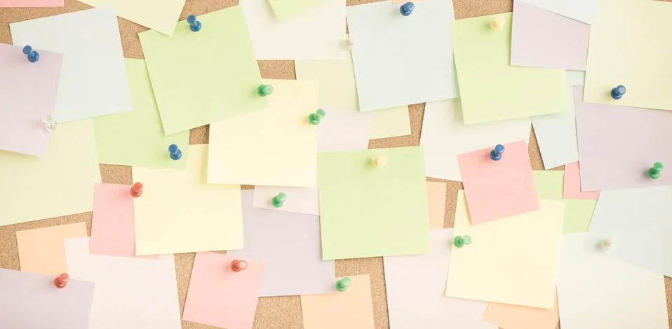 Empty blank sticky notes on notice board in office Stock Photos