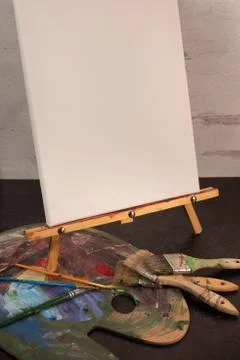 Empty blank white canvas paint pallete and paint brushes Stock Photos