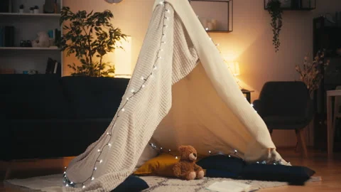 Empty blanket fort with a teddy bear, pillows and book, happy childhood, mood Vidéo 239344616