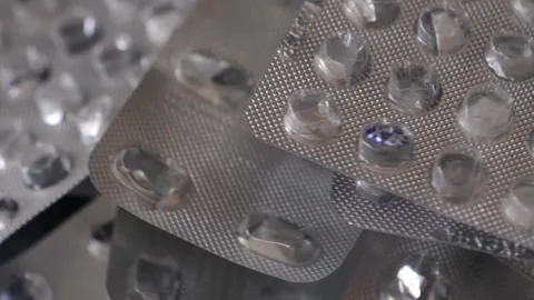 Empty blisters in a pile rotating, close-up. Video stock 304248172