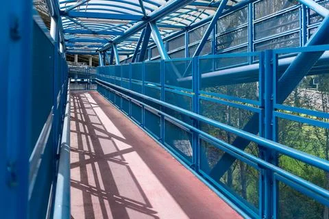 Empty blue accessible ramp and covered walkway for barrier free access Stockfoto's
