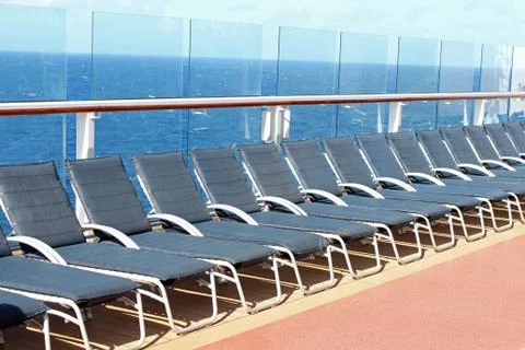 Empty blue deck chairs on a cruise ship 스톡 사진