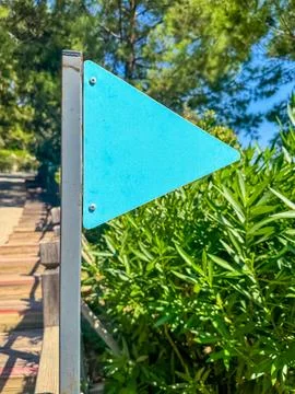 Empty blue Direction arrow. Signpost outdoor. Forest road hiking trail Stock Photos