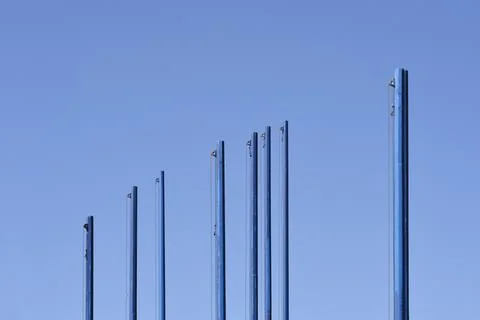 Empty blue flagpoles Stock Photos