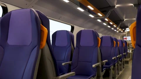 Empty blue passenger seats with yellow handles inside modern train carriage Stock Footage 345446840
