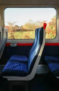 Empty blue patterned train seat, motion blur creating speed effect through .. Stock Photos