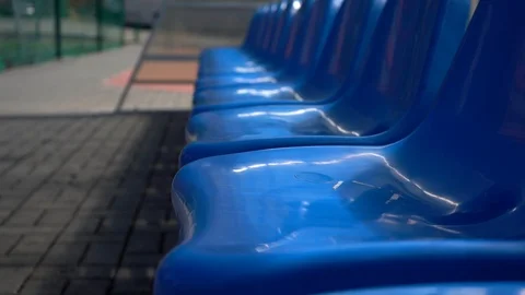 Empty blue plastic seats in outdoor sport stadium players bench, Stock Footage 126908889