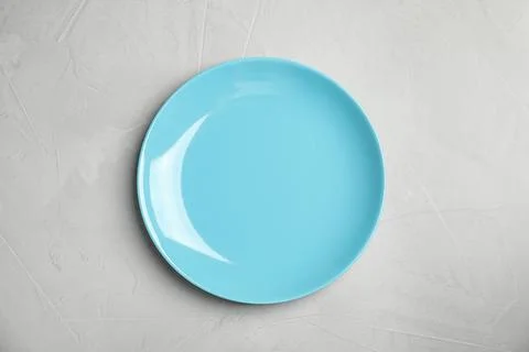 Empty  blue plate on light grey table, top view Stock Photos
