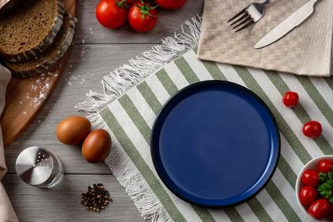An empty blue plate as serving on the table. Stock Photos