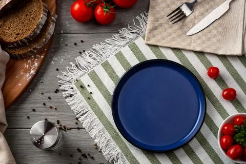 An empty blue plate as serving on the table. Stock Photos