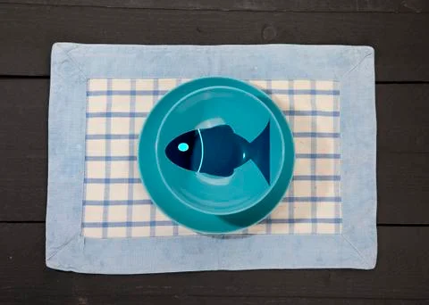 Empty blue plates on dark black wooden background Stock Photos