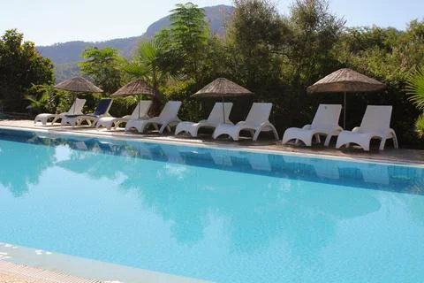 An empty blue pool and a small aqua park Foto stock
