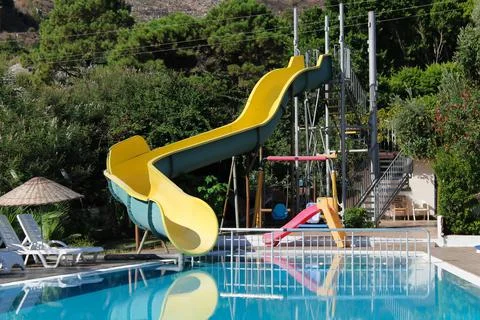 An empty blue pool and a small aqua park Foto stock