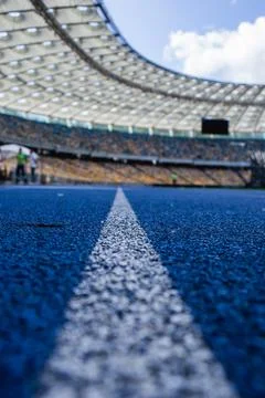 Empty blue running track at the olympic stadium Stock-Fotos