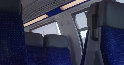 Empty blue seats and interior lighting inside moving Swiss SBB passenger train Stock Footage 341853969