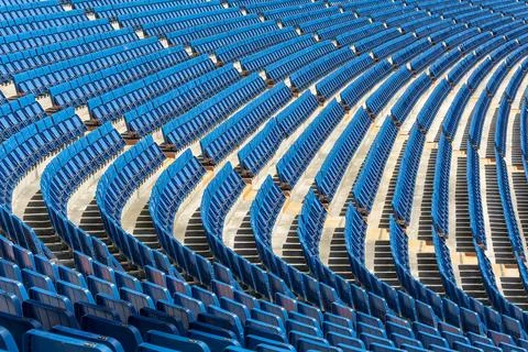 Empty Blue Stadium Seats in Curved Rows Background Stock Photos