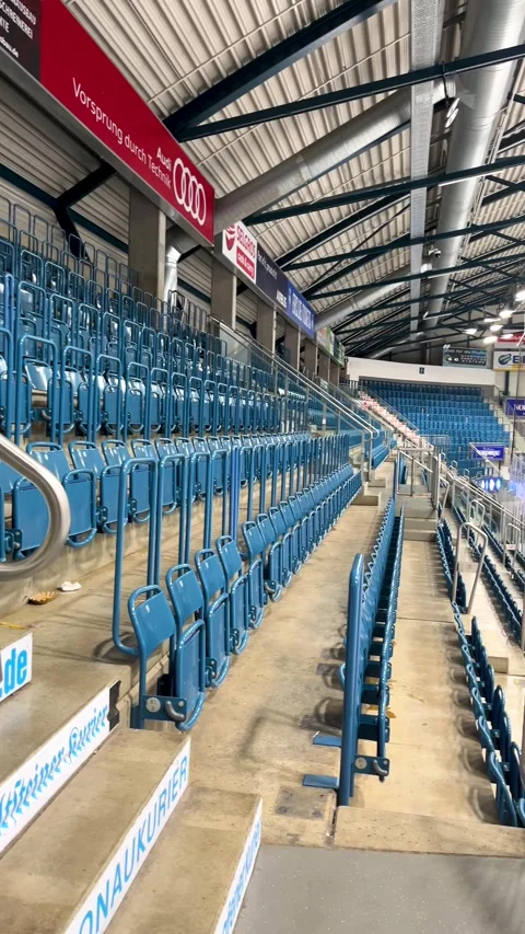 Empty Blue Stadium Seats at an Indoor Sports Arena During an Event Stock Footage 296107177
