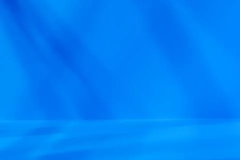 Empty blue studio space with deep artistic shadow Stock Photos