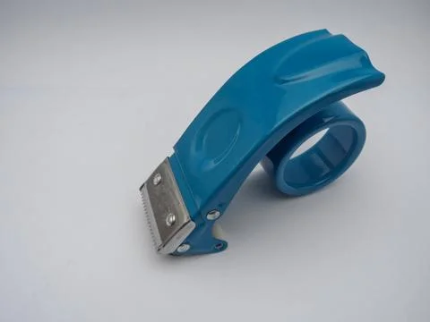 An empty blue tape dispenser without tape, isolated on a white background. Stock Photos