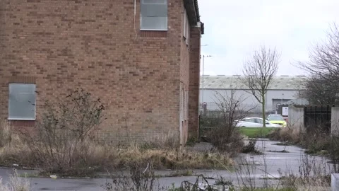 Empty boarded old peoples home with police car at side Stock Footage 260503232