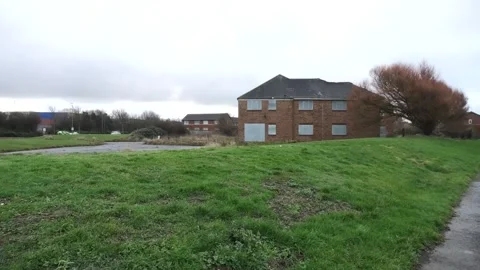 Empty boarded old peoples home with police car and winter tree Stock Footage 260503239
