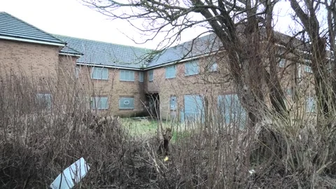 Empty boarded old peoples home rear entrance Stock Footage 260503405