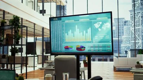 Empty boardroom setup with a computer displaying financial data Foto stock